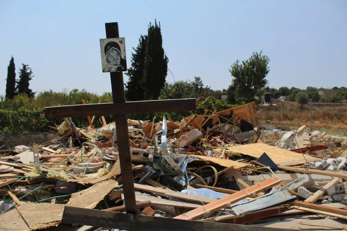 A wooden cross standing in the rubble of the Kisiya family's demolished home in Al-Makhrour near Bethlehem