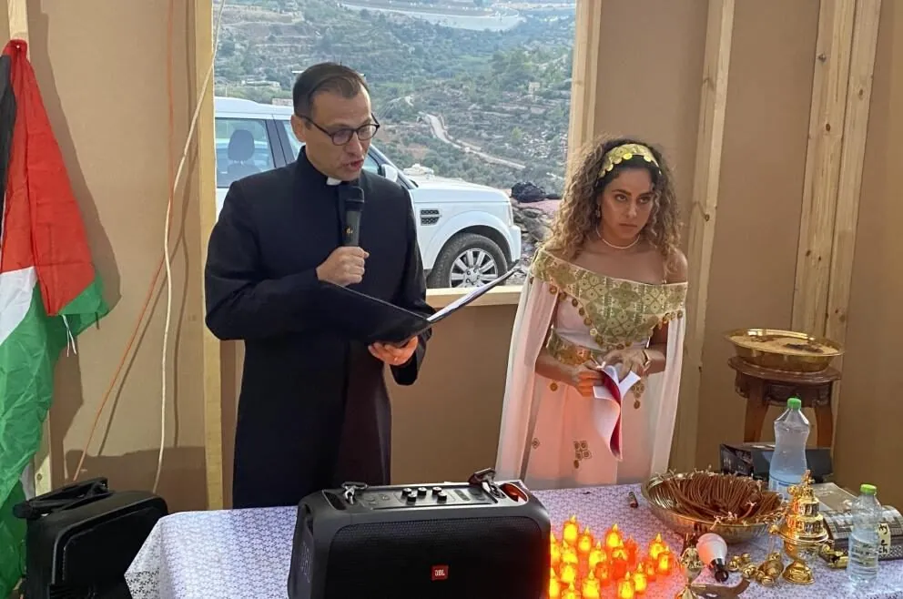 Interfaith prayer service on the Kisiya family's land in Al-Makhrour, with Alice Kisiya in traditional Palestinian dress